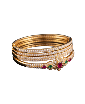 Gold-tone bangle set with brilliant stones and red and green gemstone accents