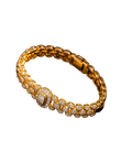 Gold-tone link bracelet covered with brilliant stone accents