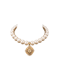 Pearl-style necklace with an ornate gold-tone medallion pendant