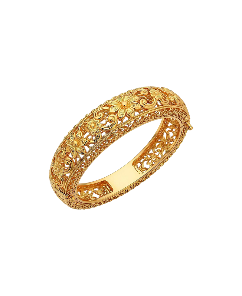 Ornate gold-tone bangle with sculpted floral and vine details