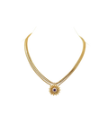 Gold-tone necklace with a floral pendant and contrasting center stone