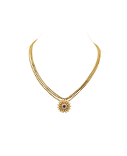 Gold-tone necklace with a floral pendant and contrasting center stone