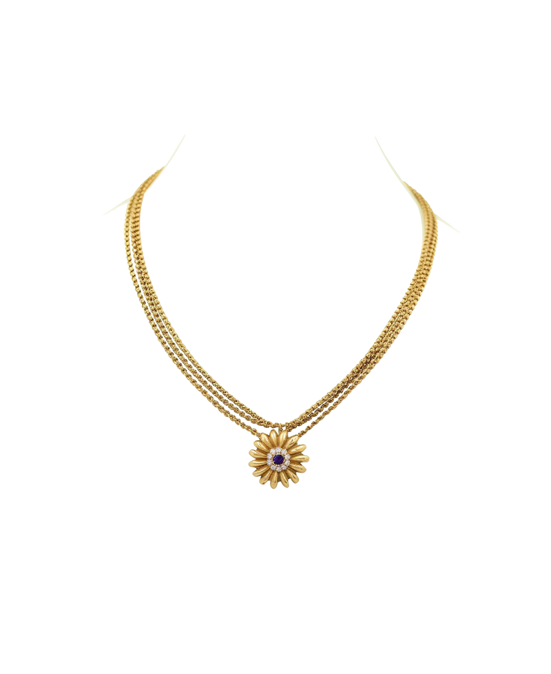 Gold-tone necklace with a floral pendant and contrasting center stone