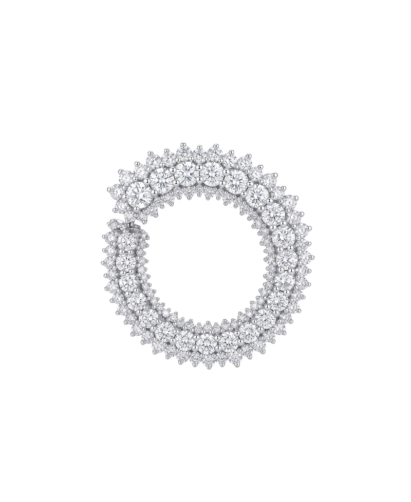Circular silver-tone jewelry piece covered with clear stones